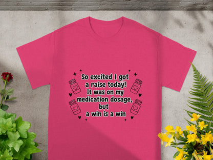 Pink t-shirt with text "So excited I got a raise today! It was on my medication dosage, but a win is a win."