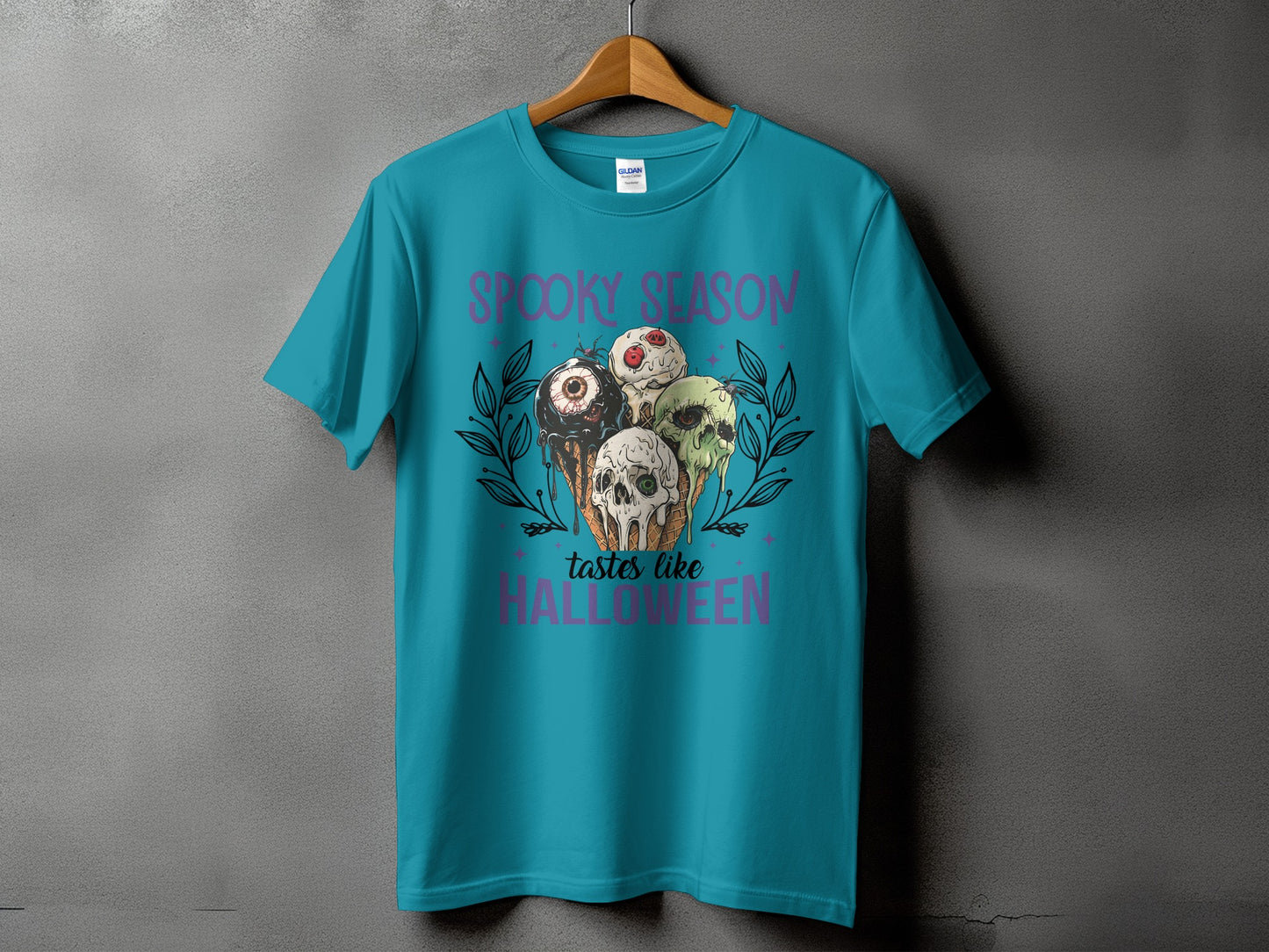 Teal t-shirt with Spooky Season text and melting Halloween ice cream cones.
