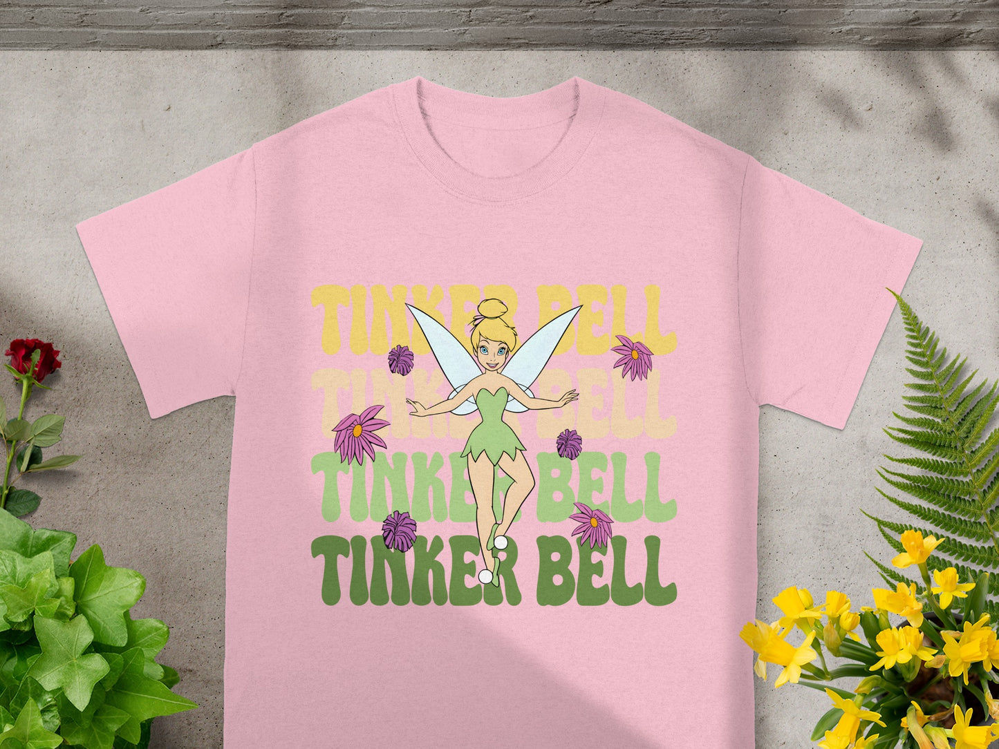 Pink t-shirt with Tinker Bell illustration and text.