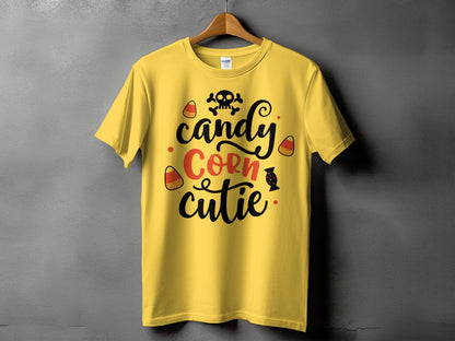 Yellow t-shirt with skull, candy corn, and text "candy Corn cutie".