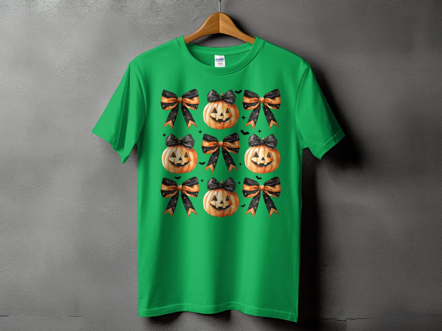 Green t-shirt with a pattern of jack-o'-lanterns and black and orange bows.