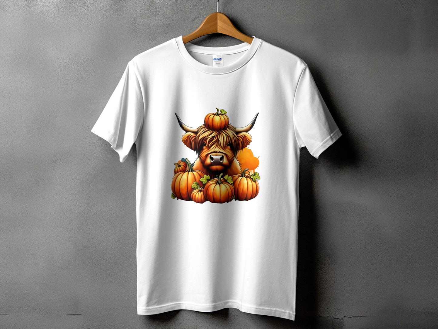White t-shirt with a highland cow and pumpkins graphic.