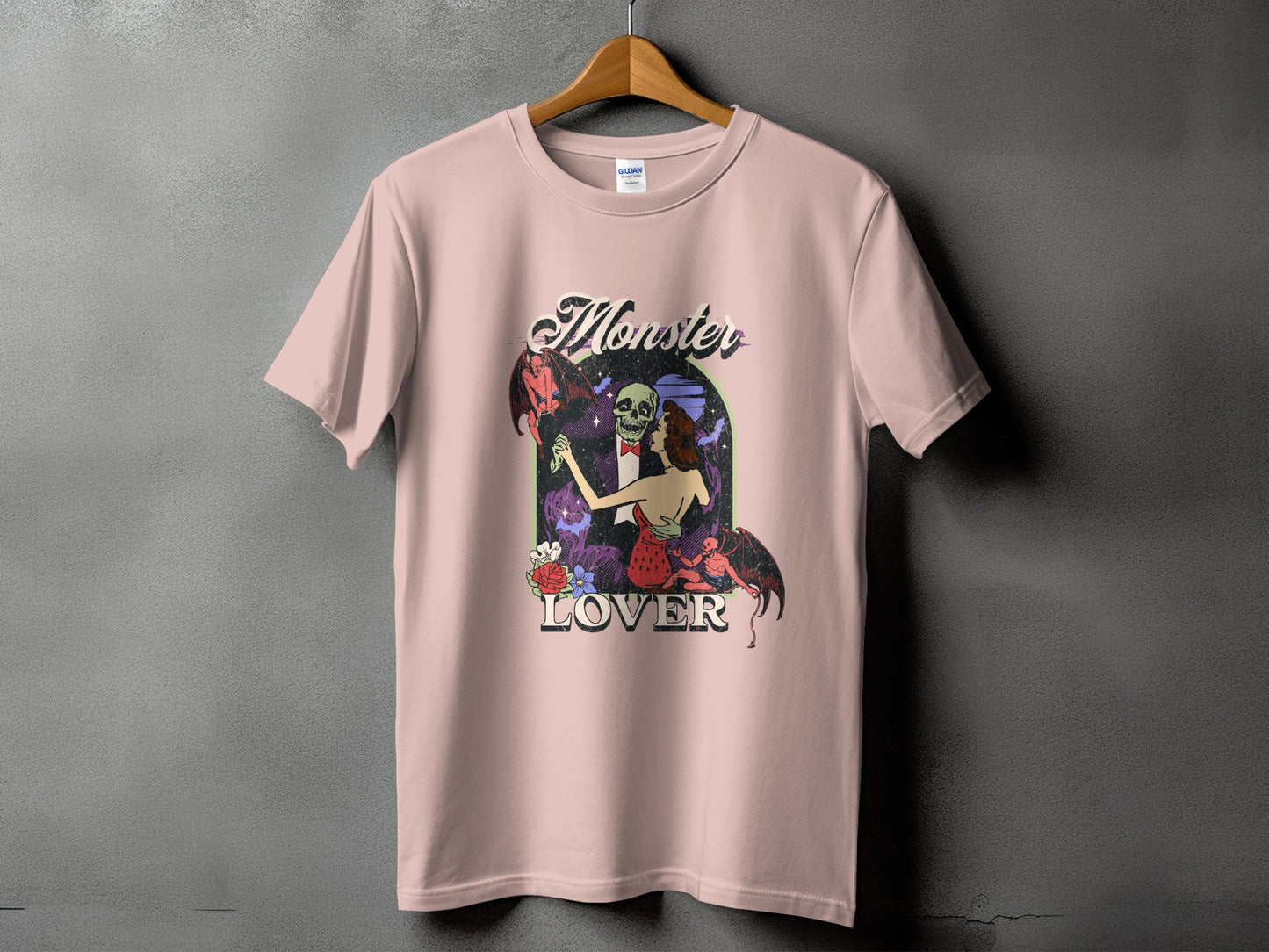 Pink t-shirt with "Monster Lover" text and a skeleton, woman, and demon graphic.