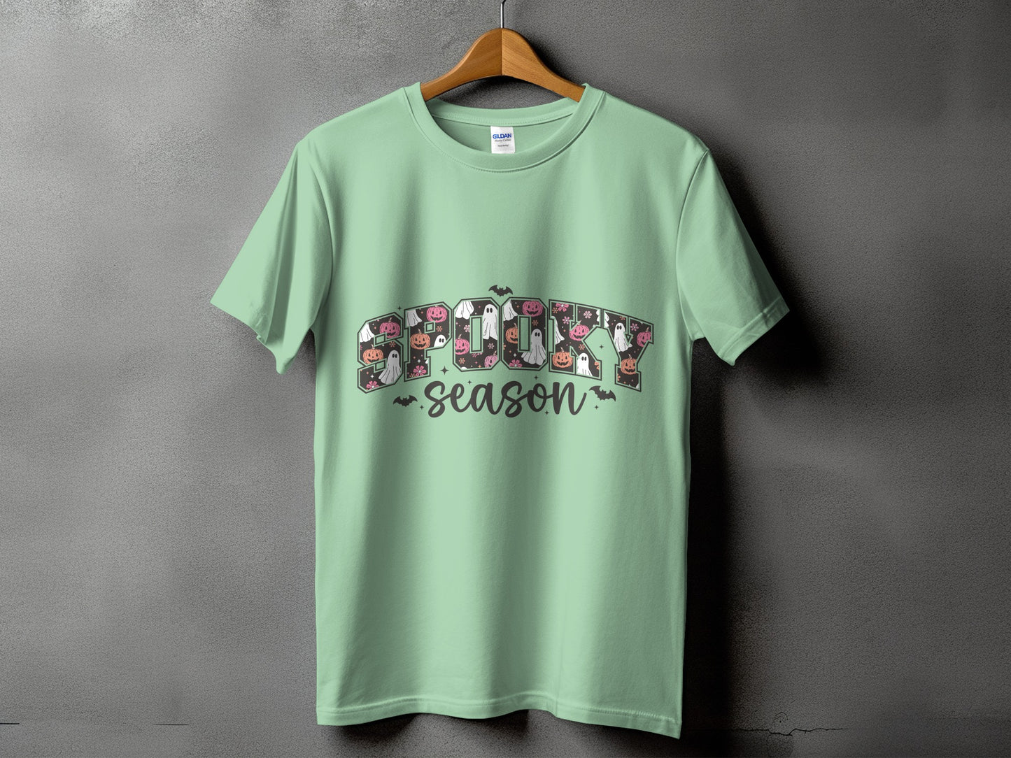 Mint t-shirt with "Spooky Season" graphic featuring ghosts and pumpkins.