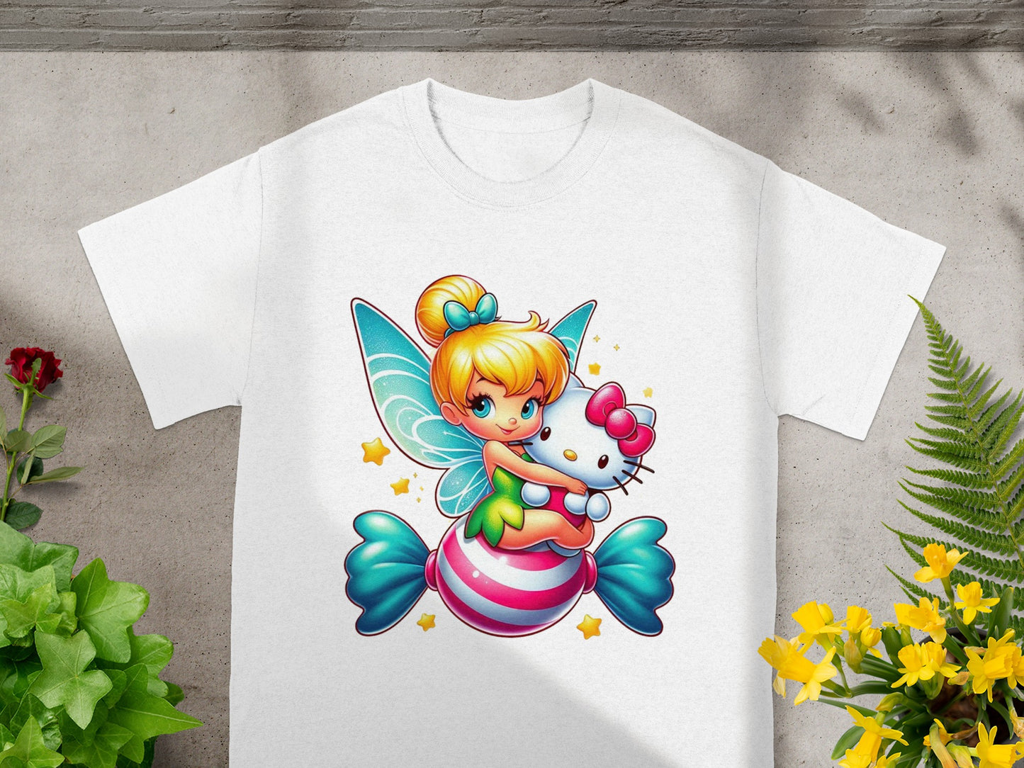 Fairy character with wings hugging a Hello Kitty plush on a candy-striped pillow.