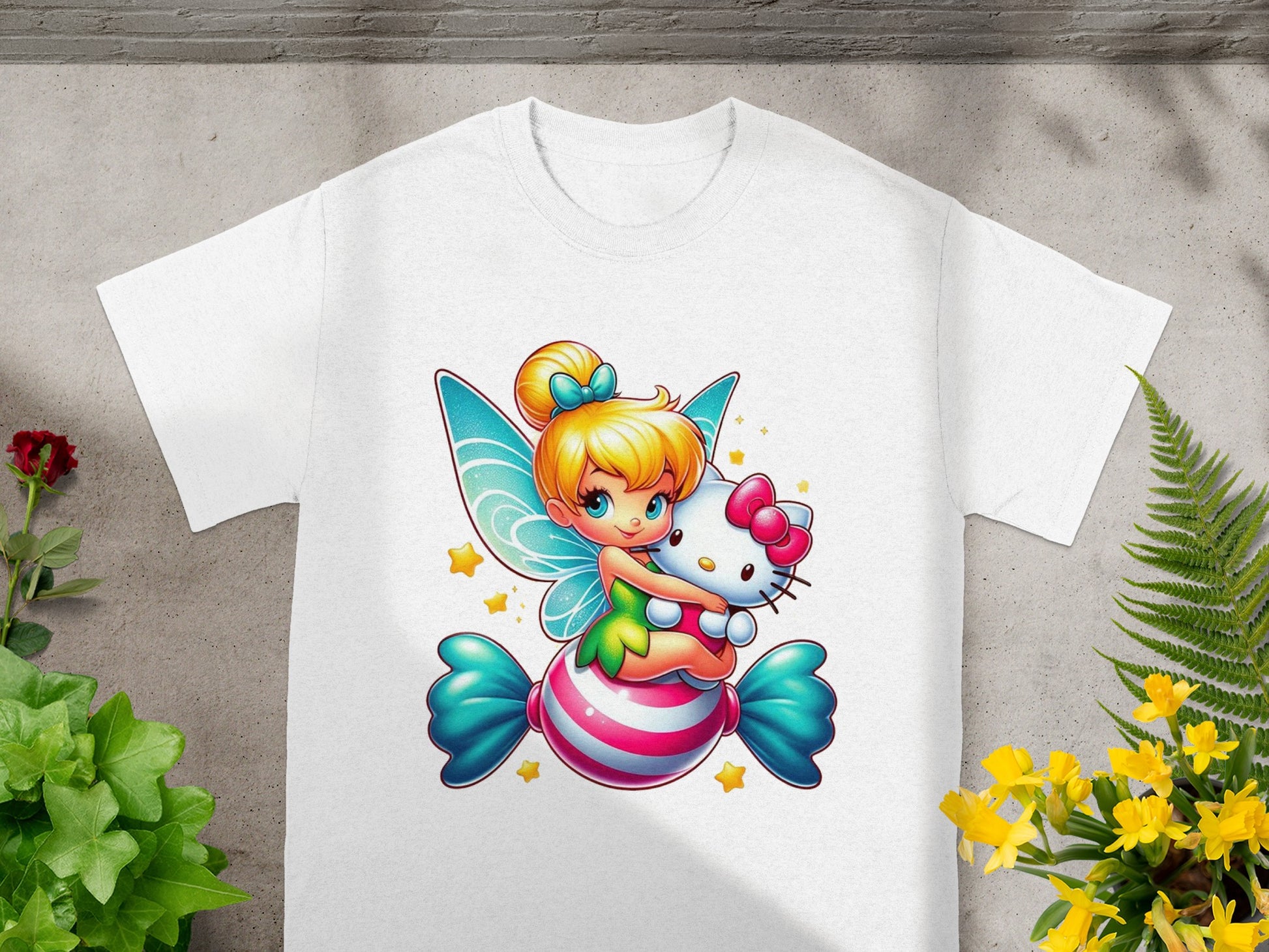Fairy character with wings hugging a Hello Kitty plush on a candy-striped pillow.