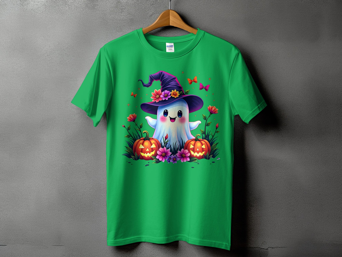 Green t-shirt with a cute ghost wearing a witch hat and pumpkins.