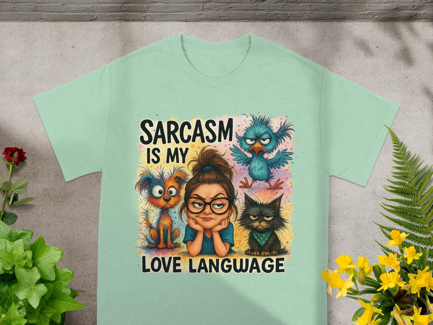 Light blue t-shirt with cartoon cat, dog, and bird design with text.