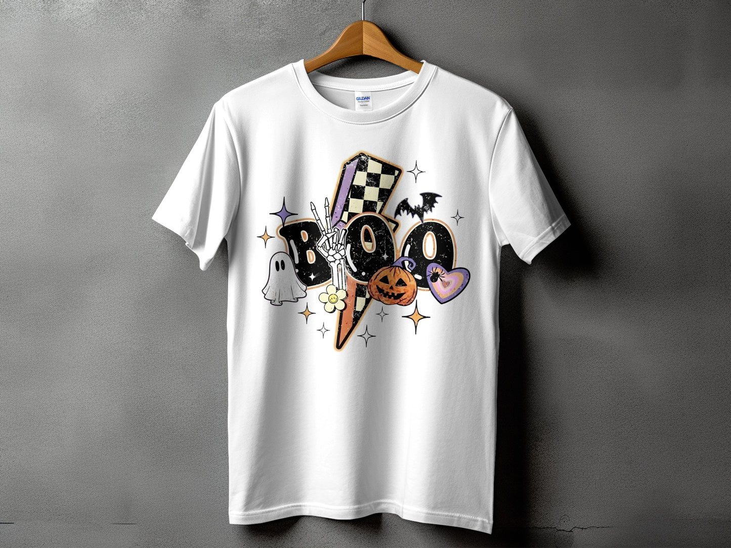 White t-shirt with a retro Halloween graphic of the word "BOO" with a ghost, pumpkin, and bat.