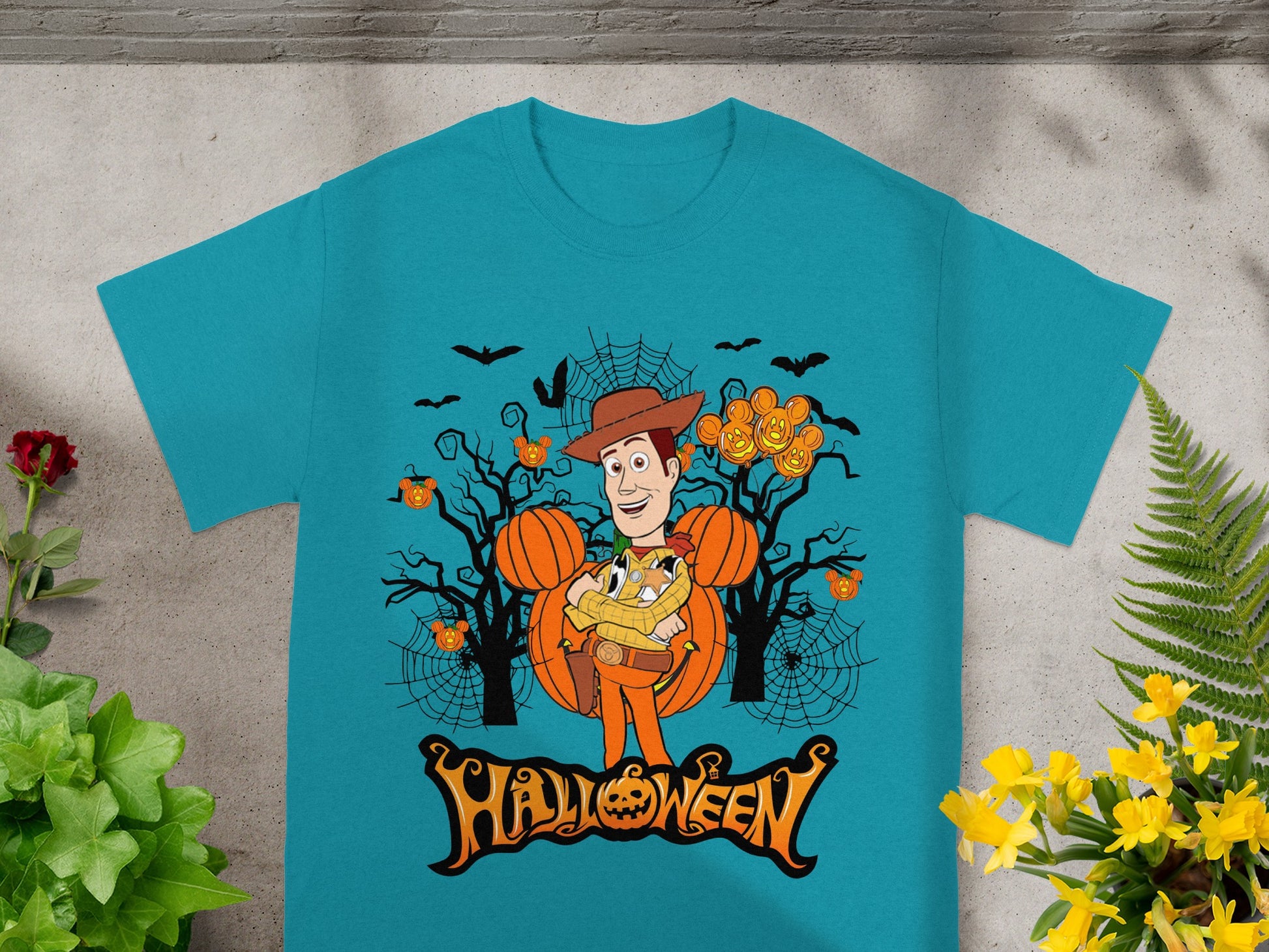 Woody character in Halloween scene with pumpkins, bats, and spiderwebs, text reads "Halloween".