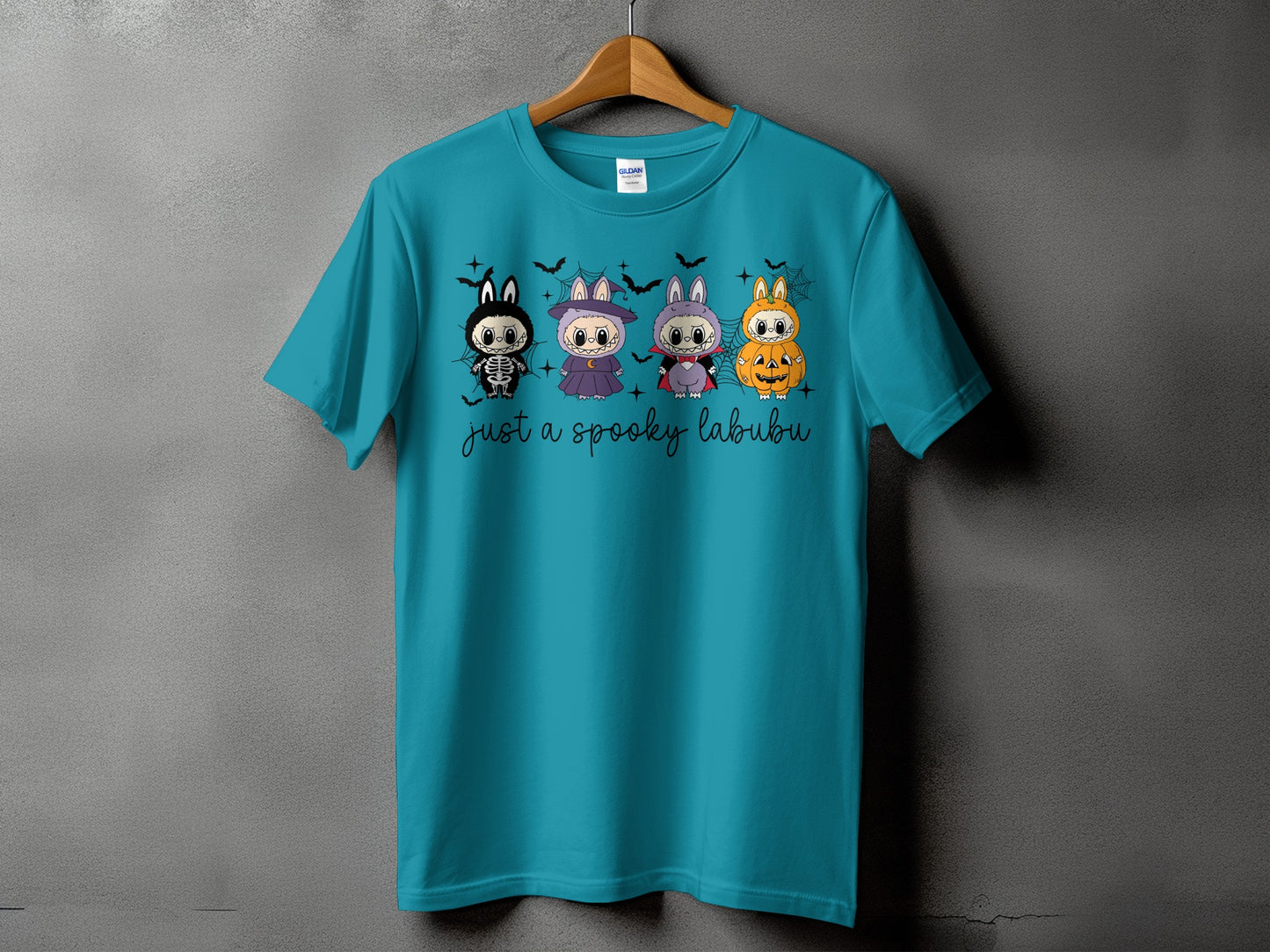 Teal t-shirt with four cute Halloween characters and text that reads "just a spooky labubu".