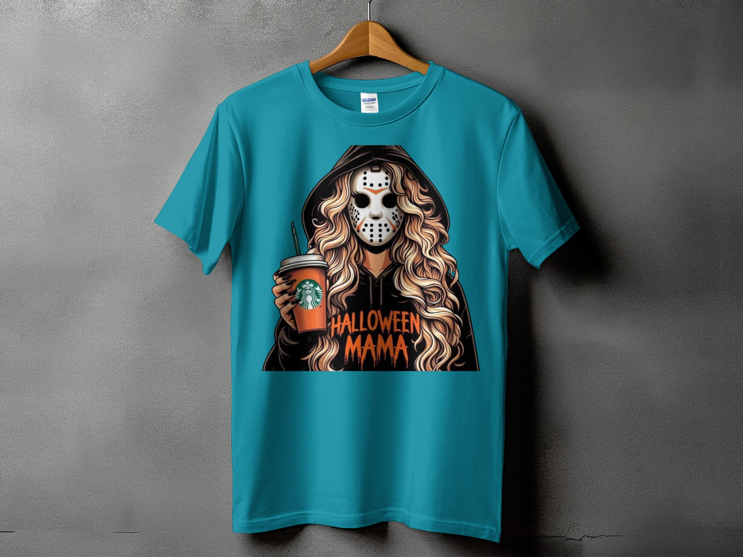 Teal t-shirt with graphic of woman in mask holding coffee cup, text "Halloween Mama."