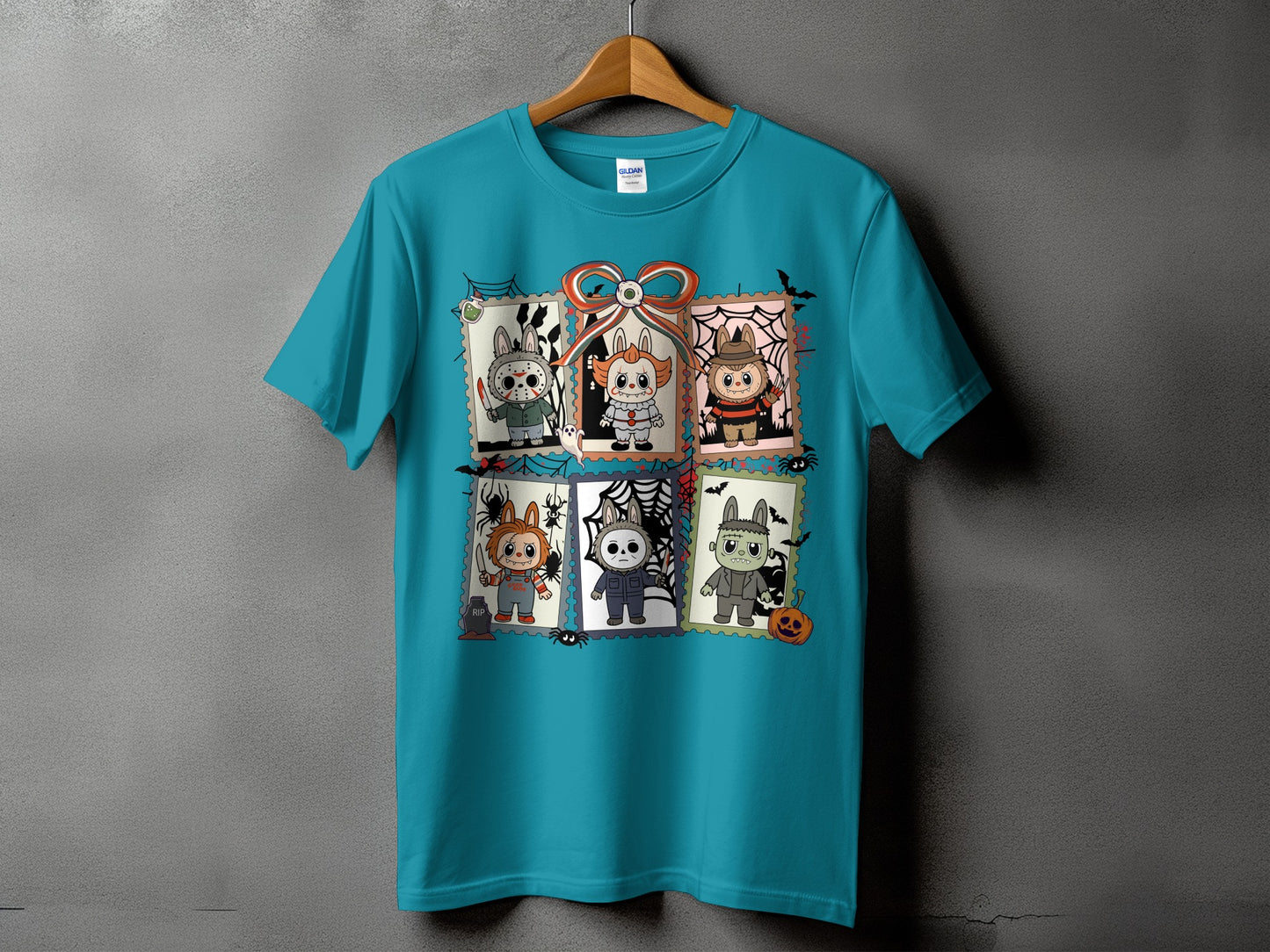 Teal t-shirt with six framed Halloween characters including Chucky, Pennywise, and Frankenstein.