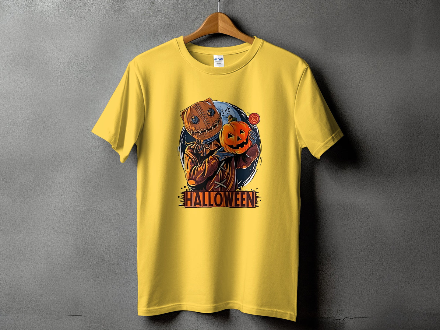 Yellow t-shirt with a Halloween illustration of a scarecrow holding a pumpkin.