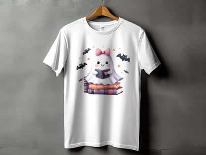 White t-shirt with a cute ghost reading a book surrounded by bats and stars.