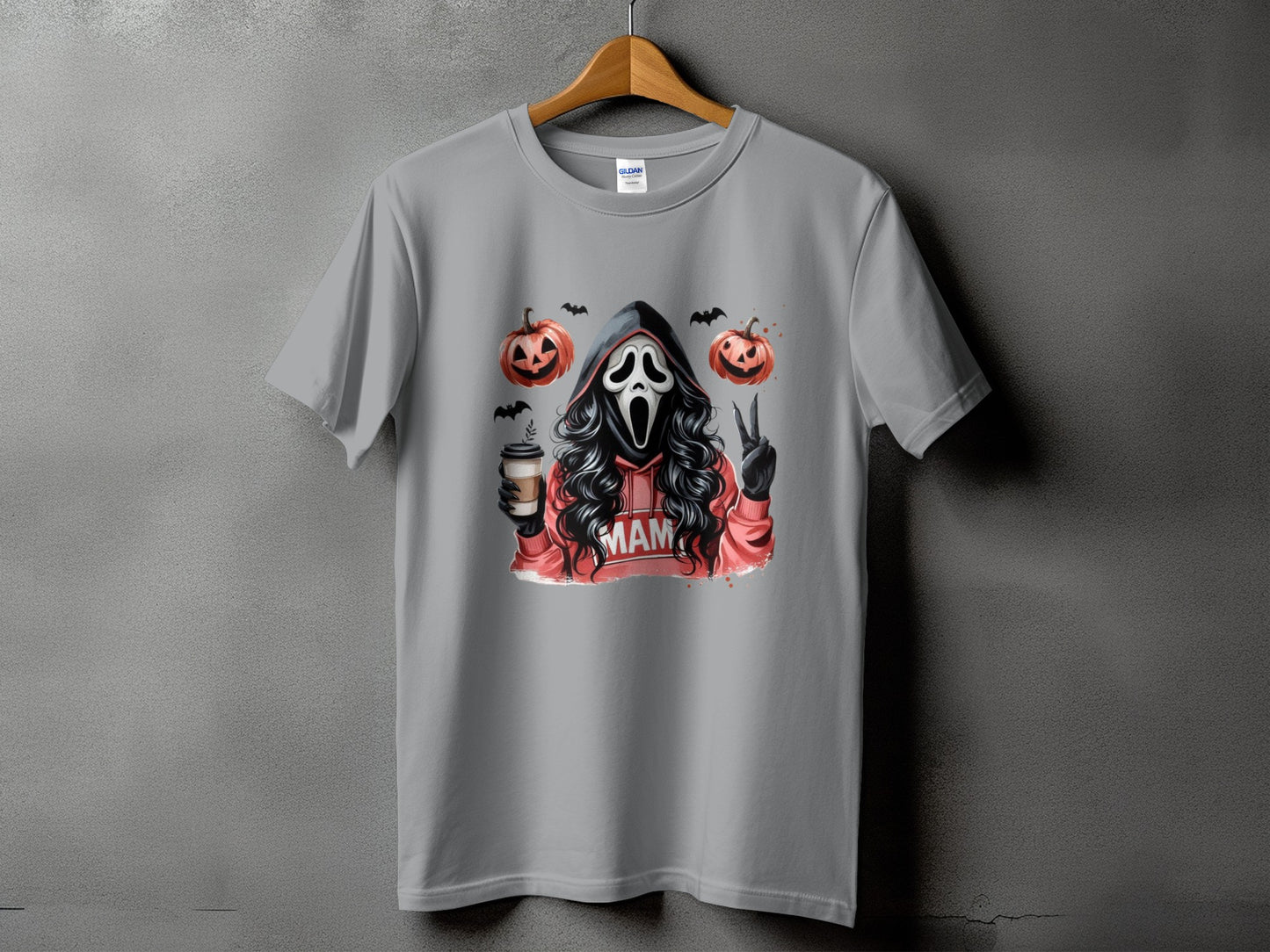 Ghostface holding coffee with pumpkins, bats, and "MAM" on hoodie.