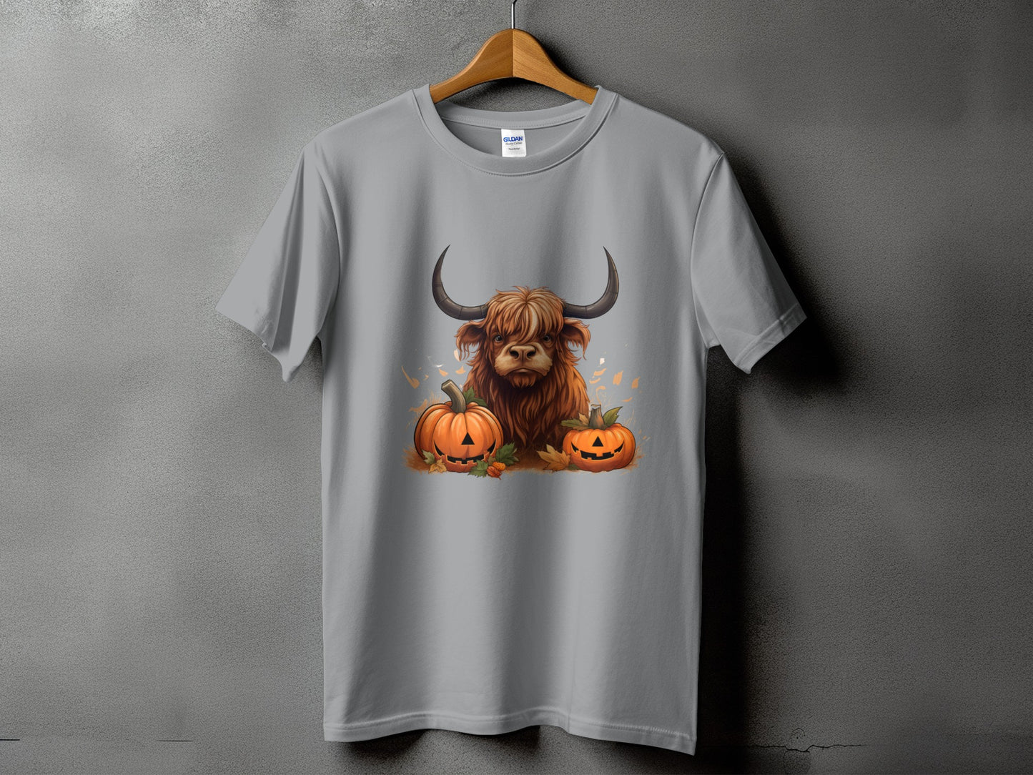 Scottish Highland cow with pumpkins and fall leaves graphic on a grey t-shirt.