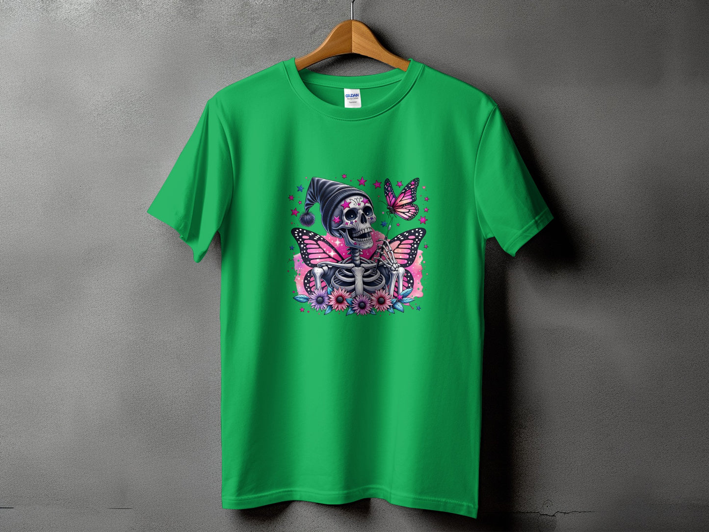 Green t-shirt with a skeleton adorned with butterfly wings and flowers graphic.