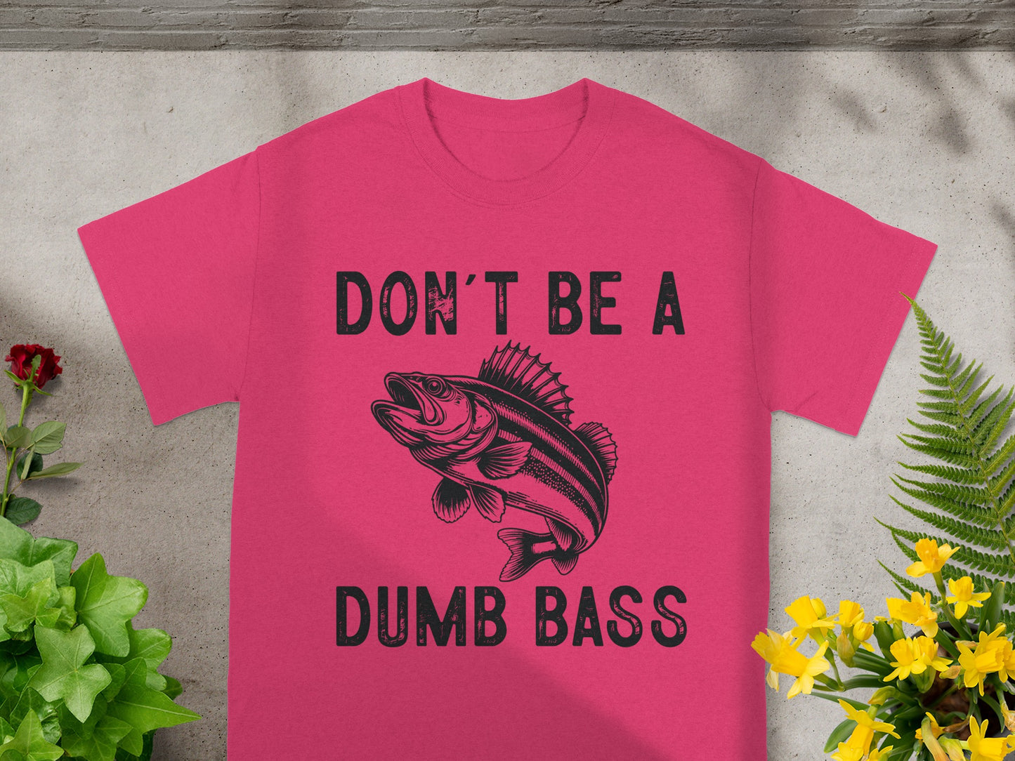 Pink t-shirt with black text and a bass fish graphic.
