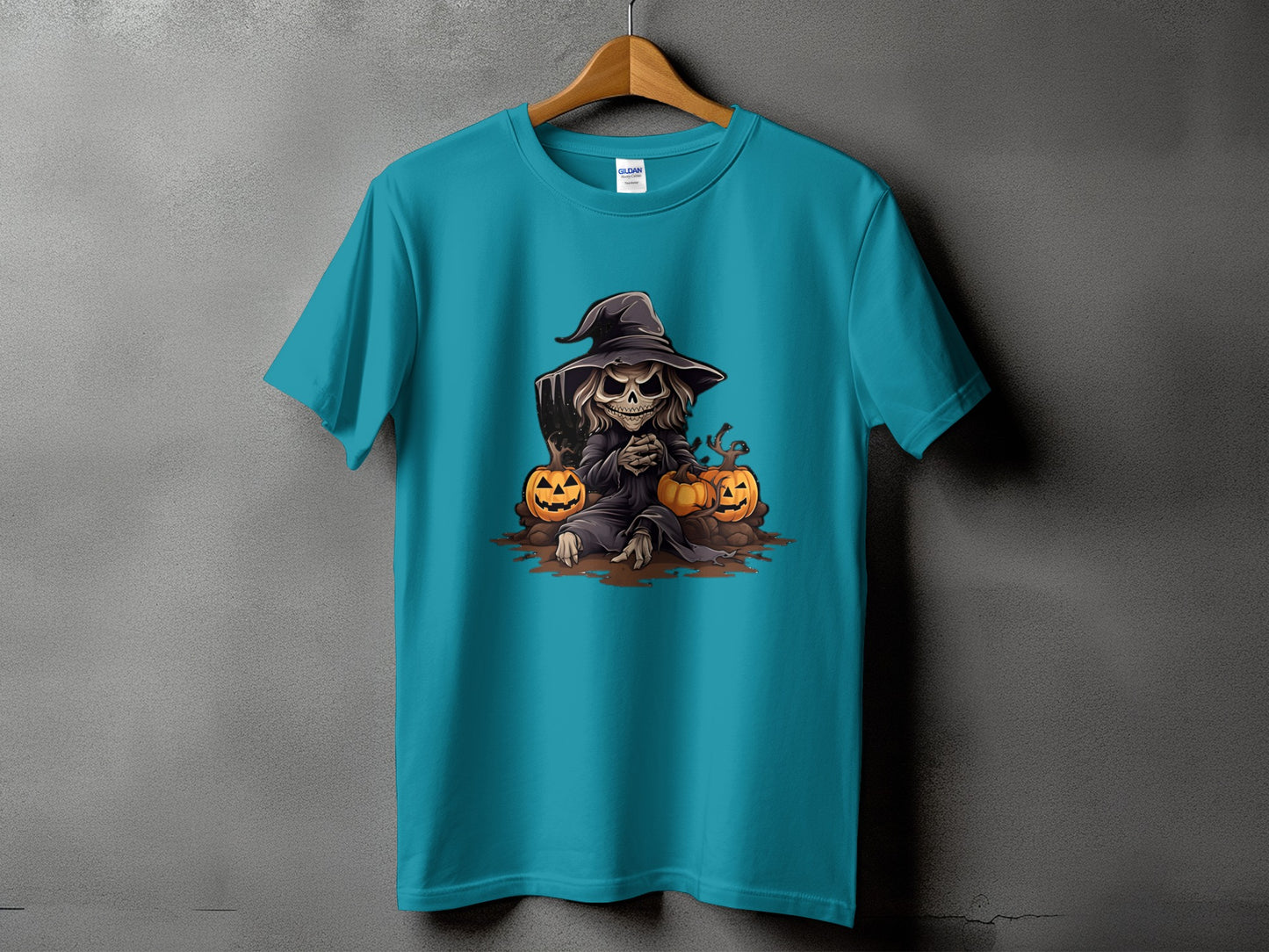 Teal t-shirt with skeleton witch and pumpkins Halloween graphic.