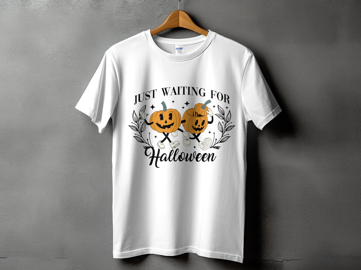 White t-shirt with "Just Waiting For Halloween" graphic featuring cartoon pumpkins.