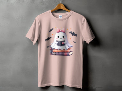 Pink t-shirt with a cute ghost reading a book surrounded by bats.