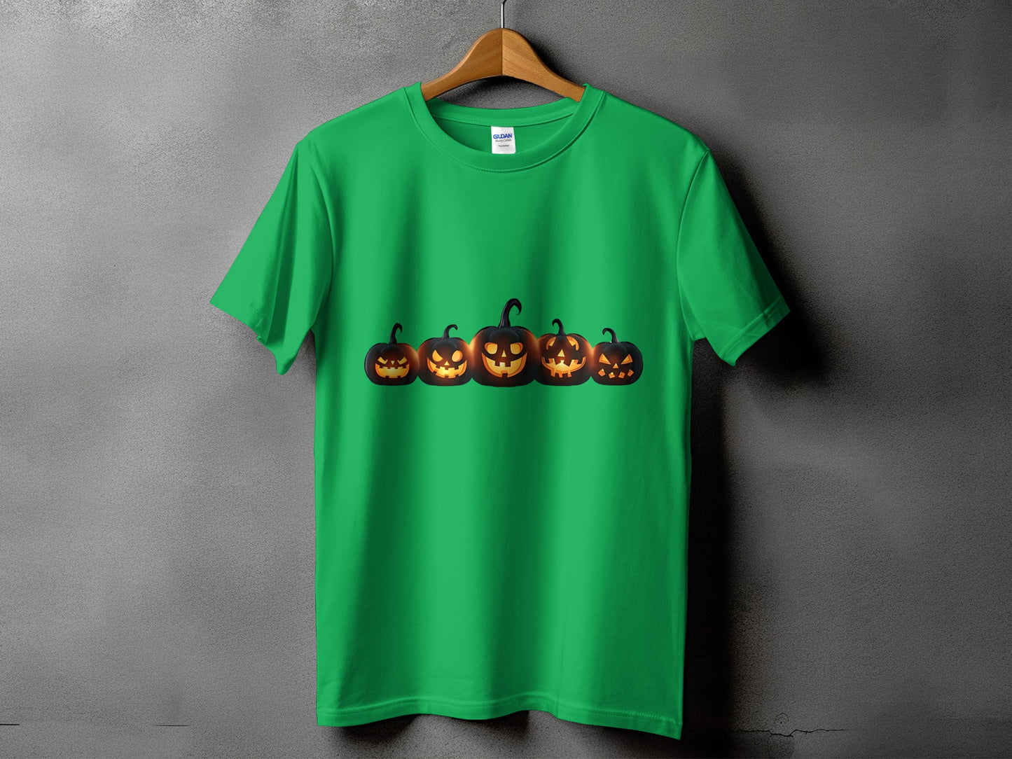 Green t-shirt with a row of glowing jack-o'-lanterns across the chest.