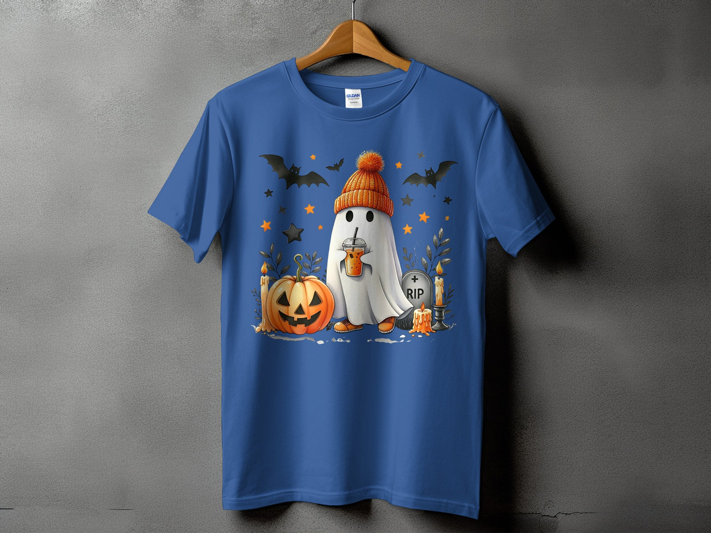 Blue t-shirt with ghost wearing orange hat, holding drink, with pumpkin and bats.