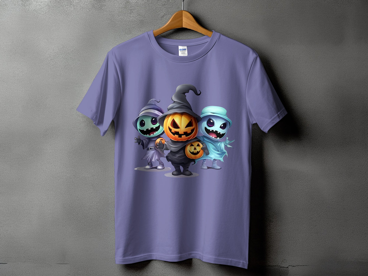 Purple t-shirt featuring three cartoon Halloween characters: a witch, a pumpkin, and a ghost.