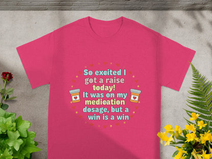 Pink t-shirt with text "So excited I got a raise today! It was on my medication dosage, but a win is a win".