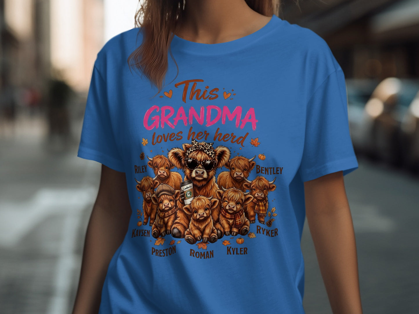 Blue t-shirt with "This GRANDMA loves her herd" and highland cows named Riley, Bentley, Kaysen, Preston, Roman, Kyler, and Ryker.