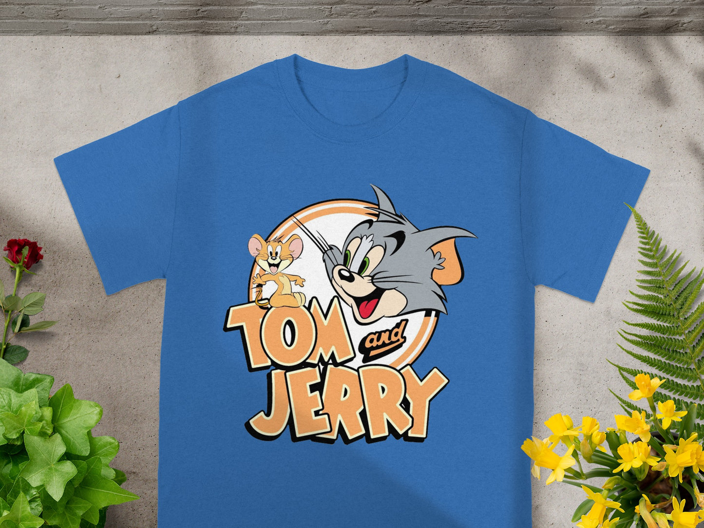 Blue t-shirt featuring Tom and Jerry cartoon characters and logo.