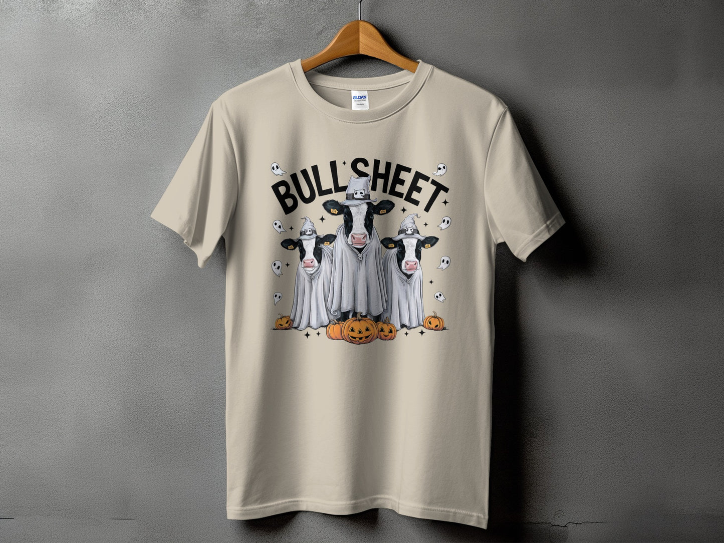 Three cows in ghost costumes with pumpkins and text "BULL'SHEET".