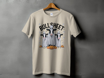 Three cows in ghost costumes with pumpkins and text "BULL'SHEET".