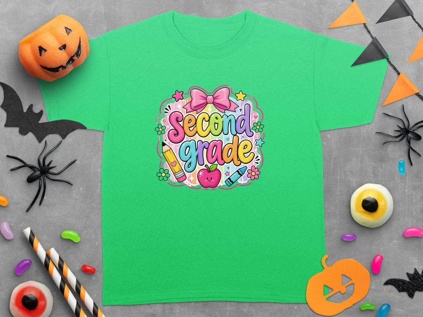 Green t-shirt with "Second grade" text featuring cute school supplies and Halloween decor.