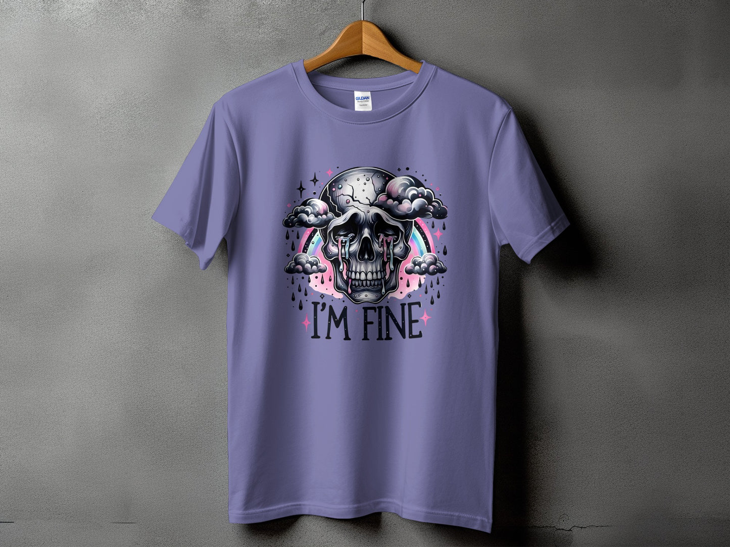 Lavender t-shirt with a skull graphic, rainbow, clouds, and "I'M FINE" text.