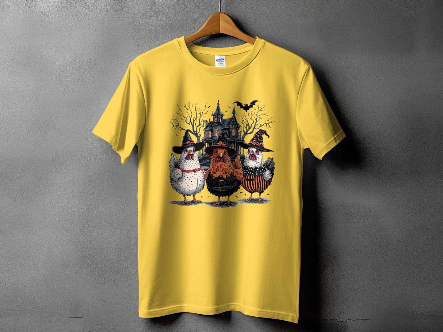 Yellow t-shirt with Halloween graphic of three chickens in costumes and a haunted house.