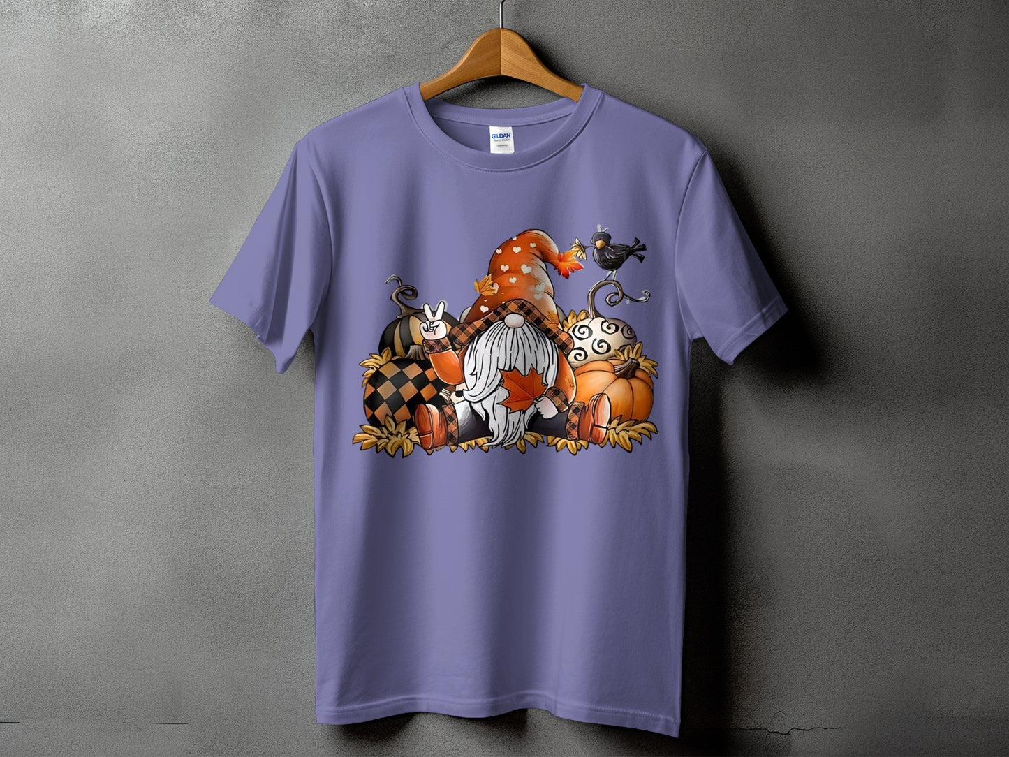 Purple t-shirt featuring a gnome with pumpkins, leaves, and a crow in a fall theme.