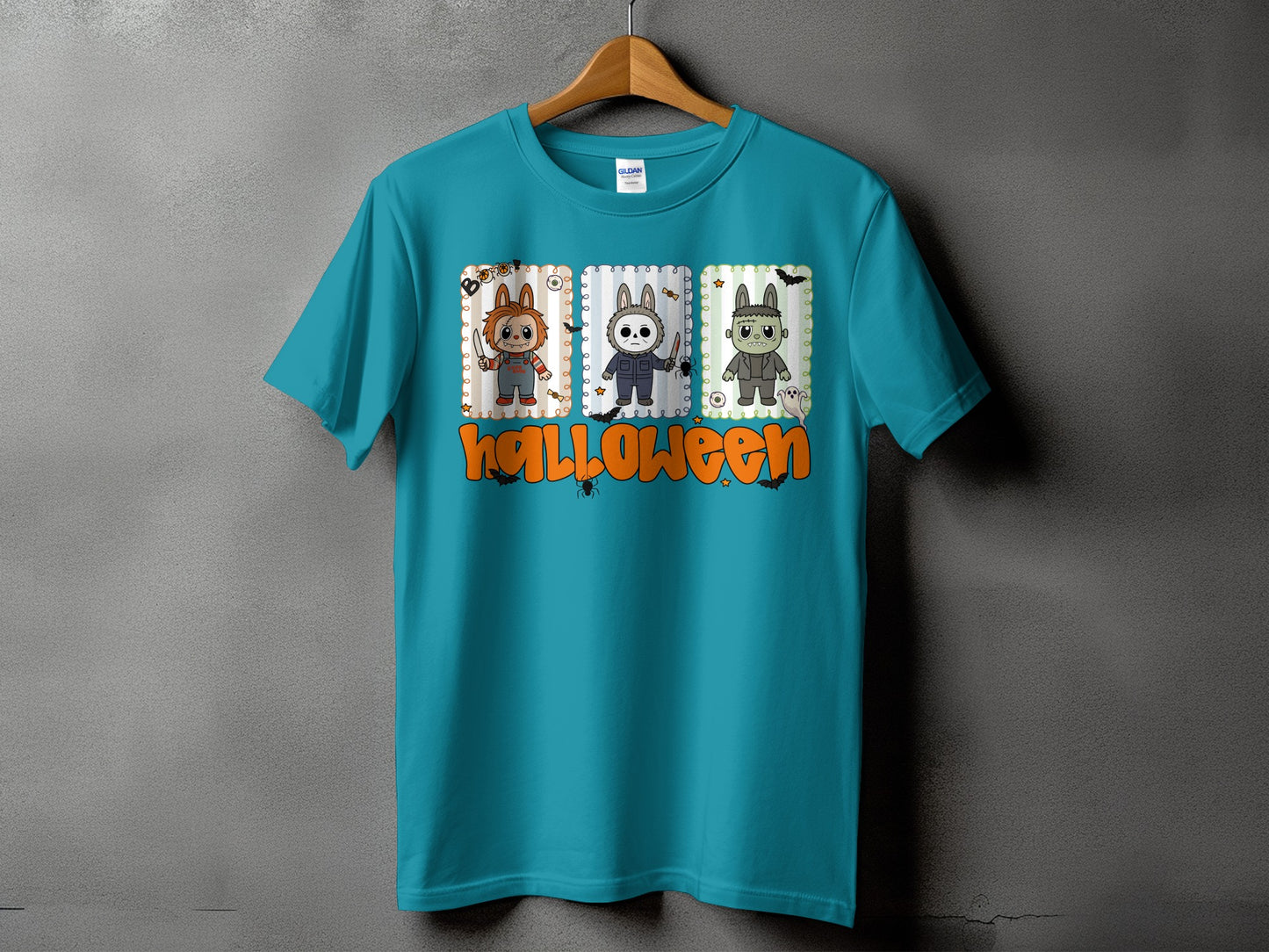 Teal t-shirt with three Halloween character panels and "Halloween" text.