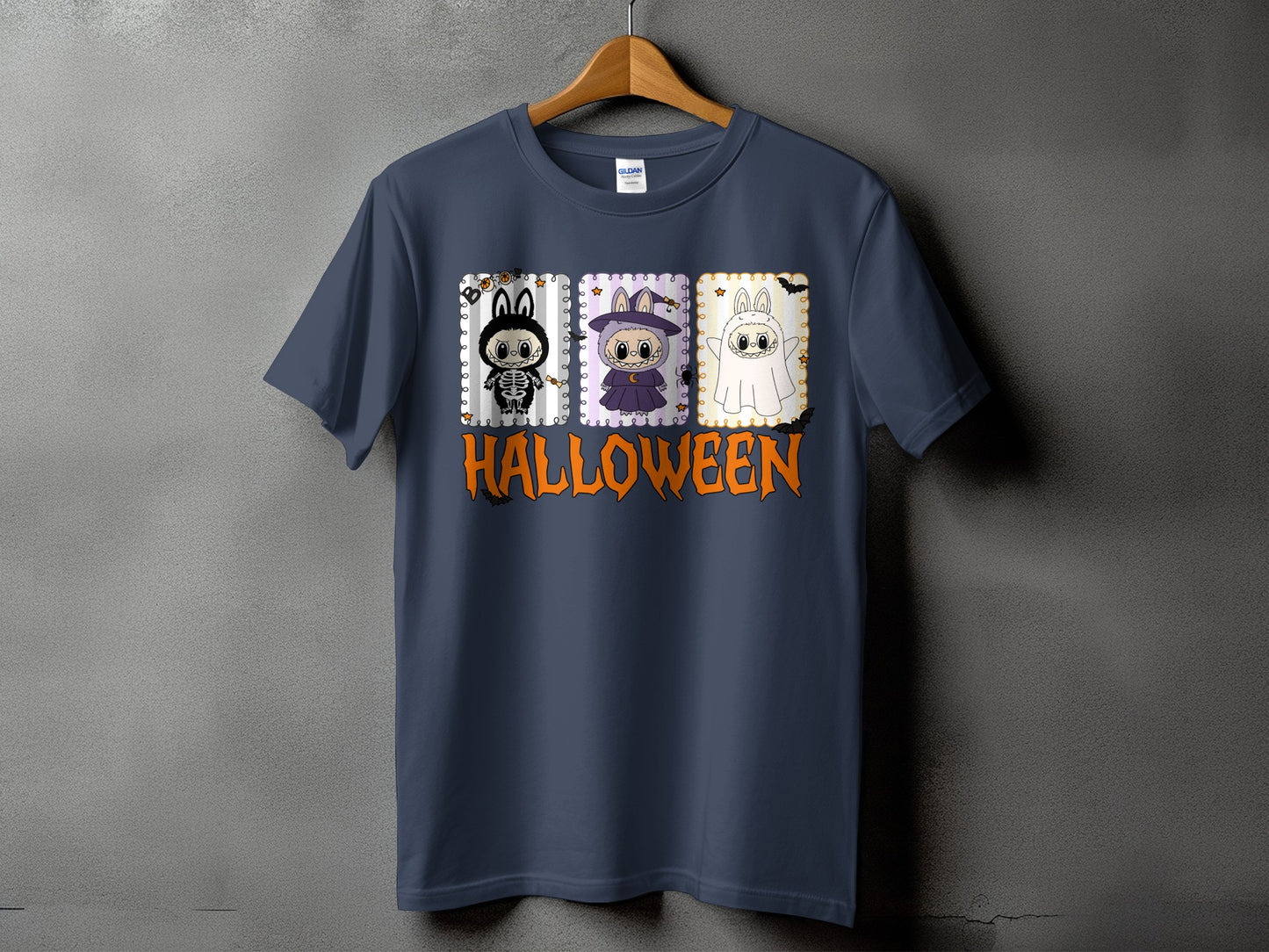 Dark blue t-shirt with three Halloween-themed cartoon rabbits and orange text.