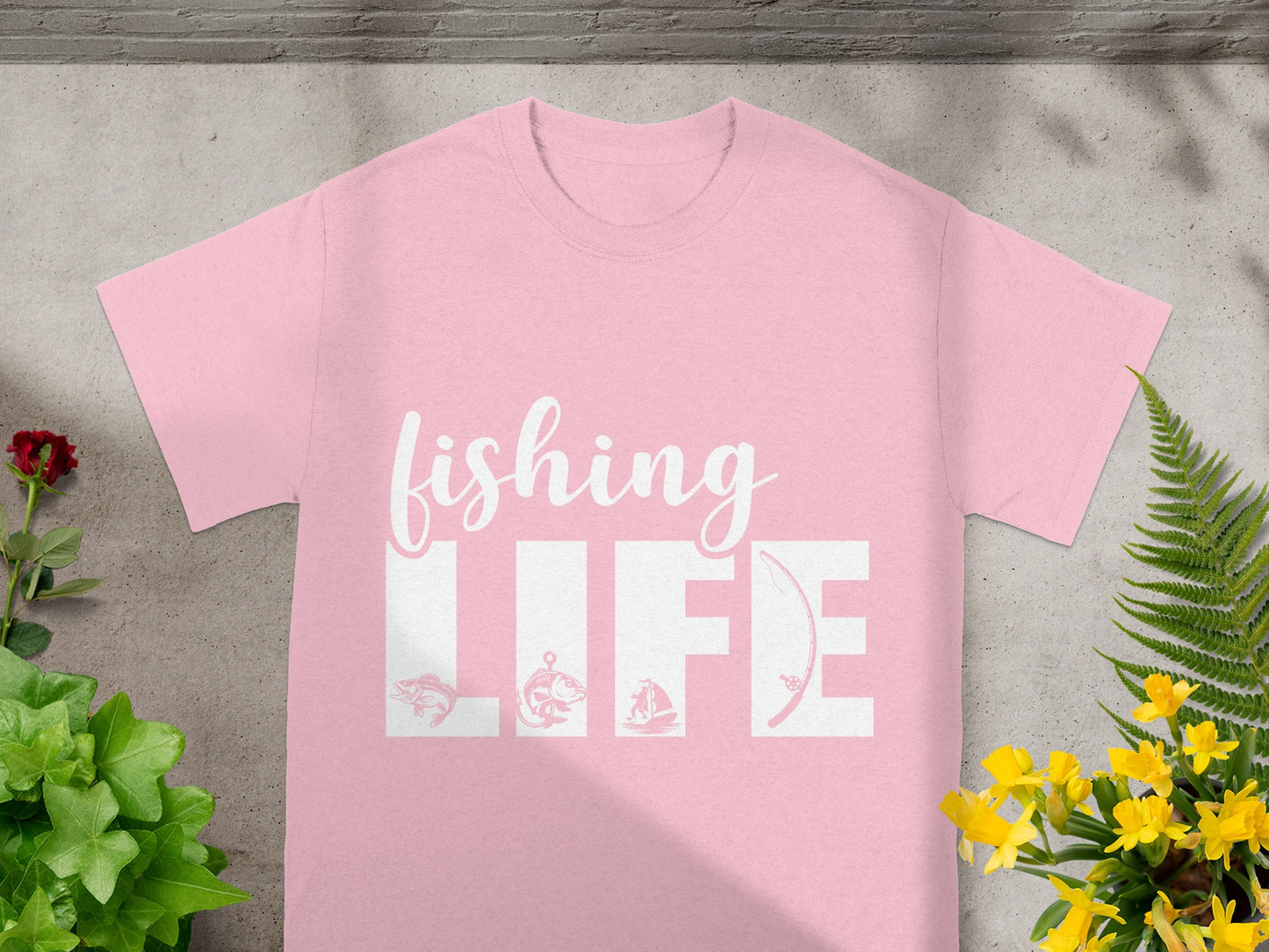Pink t-shirt with white text "fishing LIFE" and fishing-themed graphics.