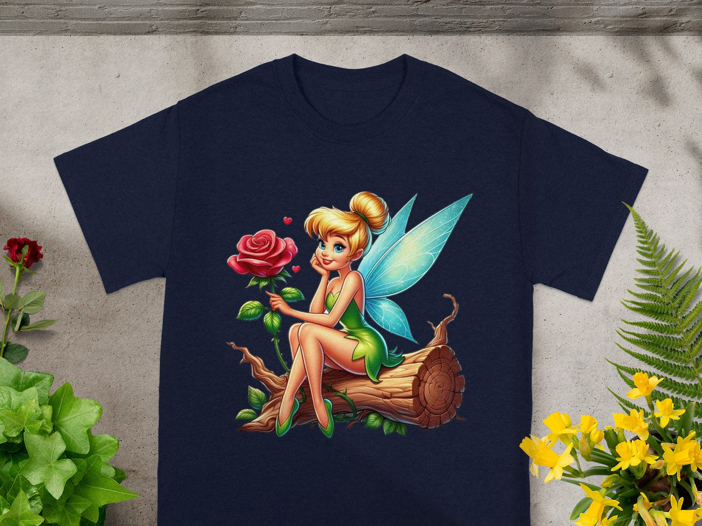 Tinkerbell sits on a log holding a rose.