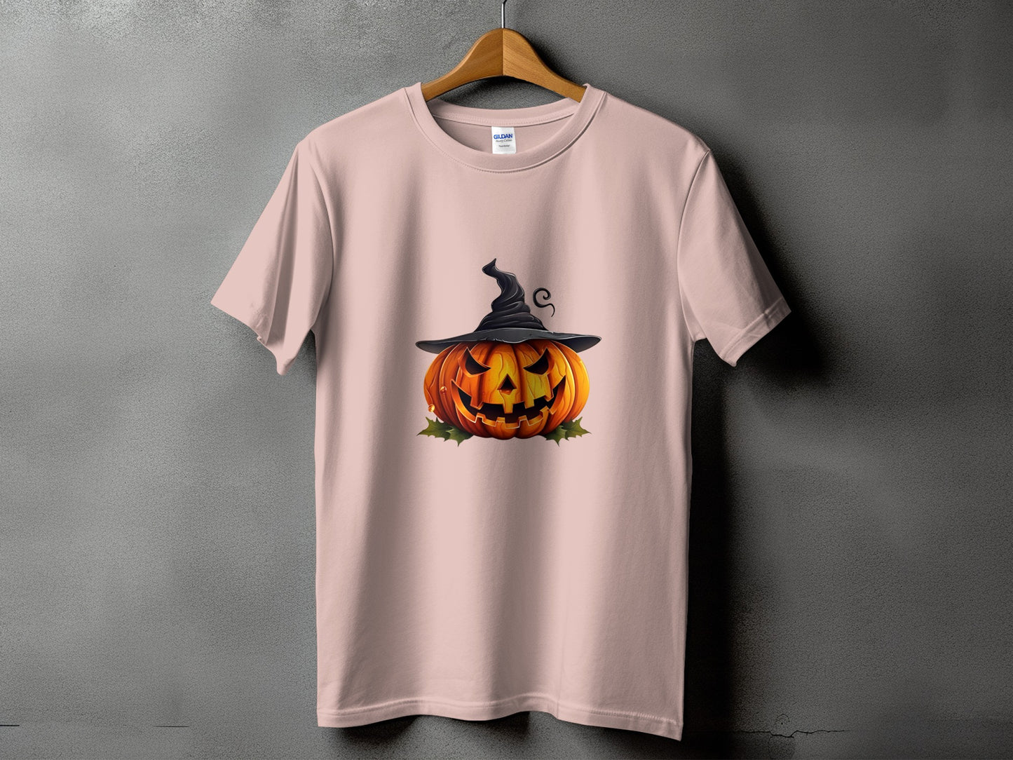 Pink t-shirt with a jack-o'-lantern wearing a witch hat graphic.