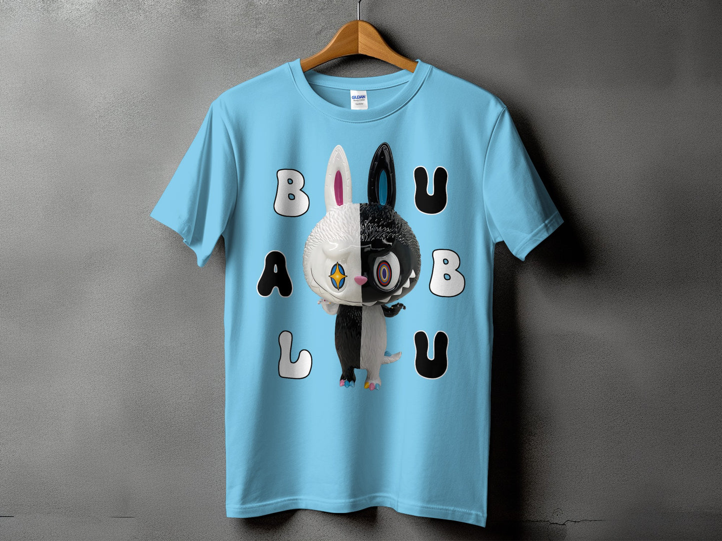 Light blue t-shirt with a half white, half black bunny character and the text BU A L U.