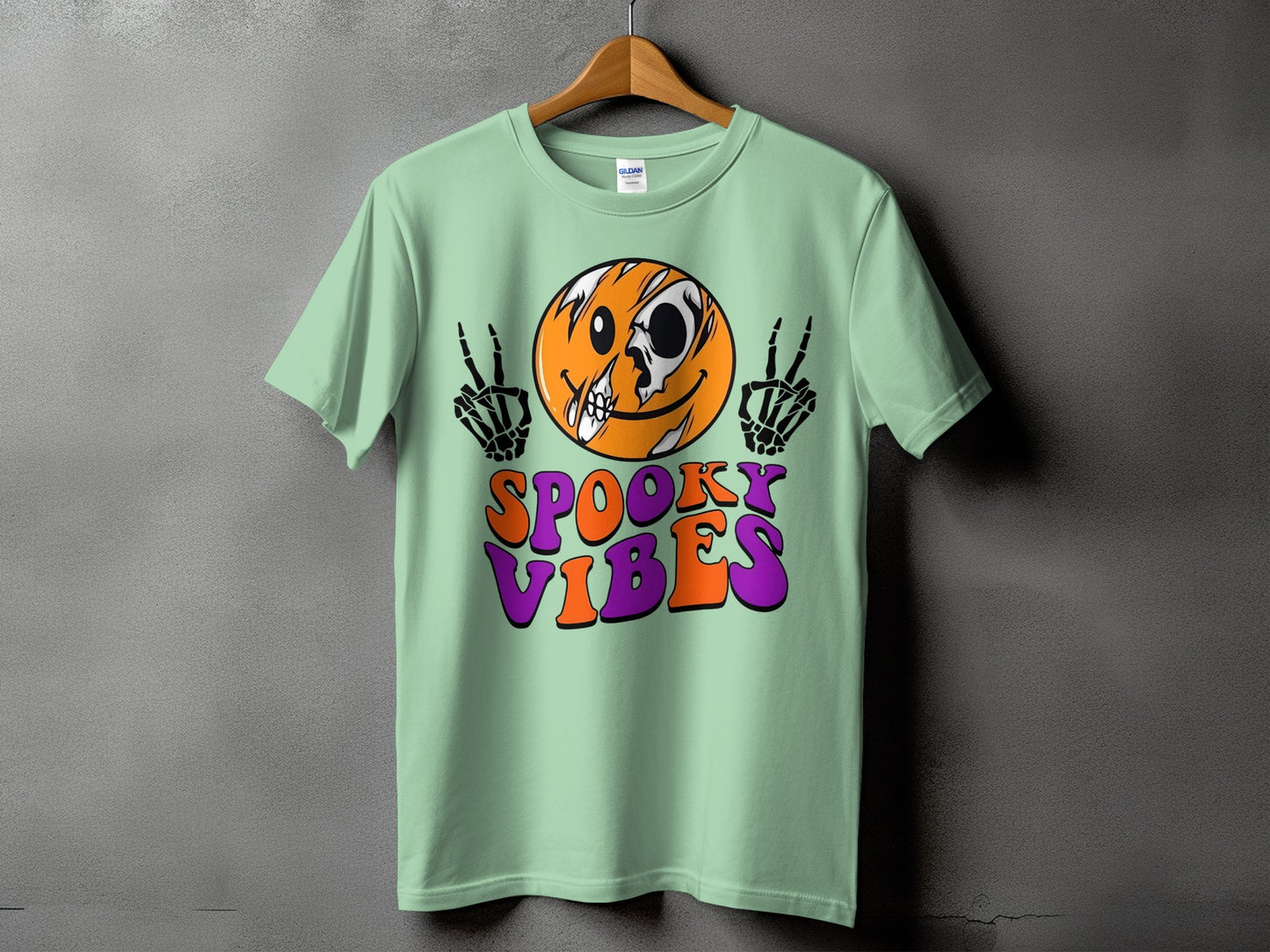 Light green t-shirt with a skull-faced smiley and "Spooky Vibes" text.