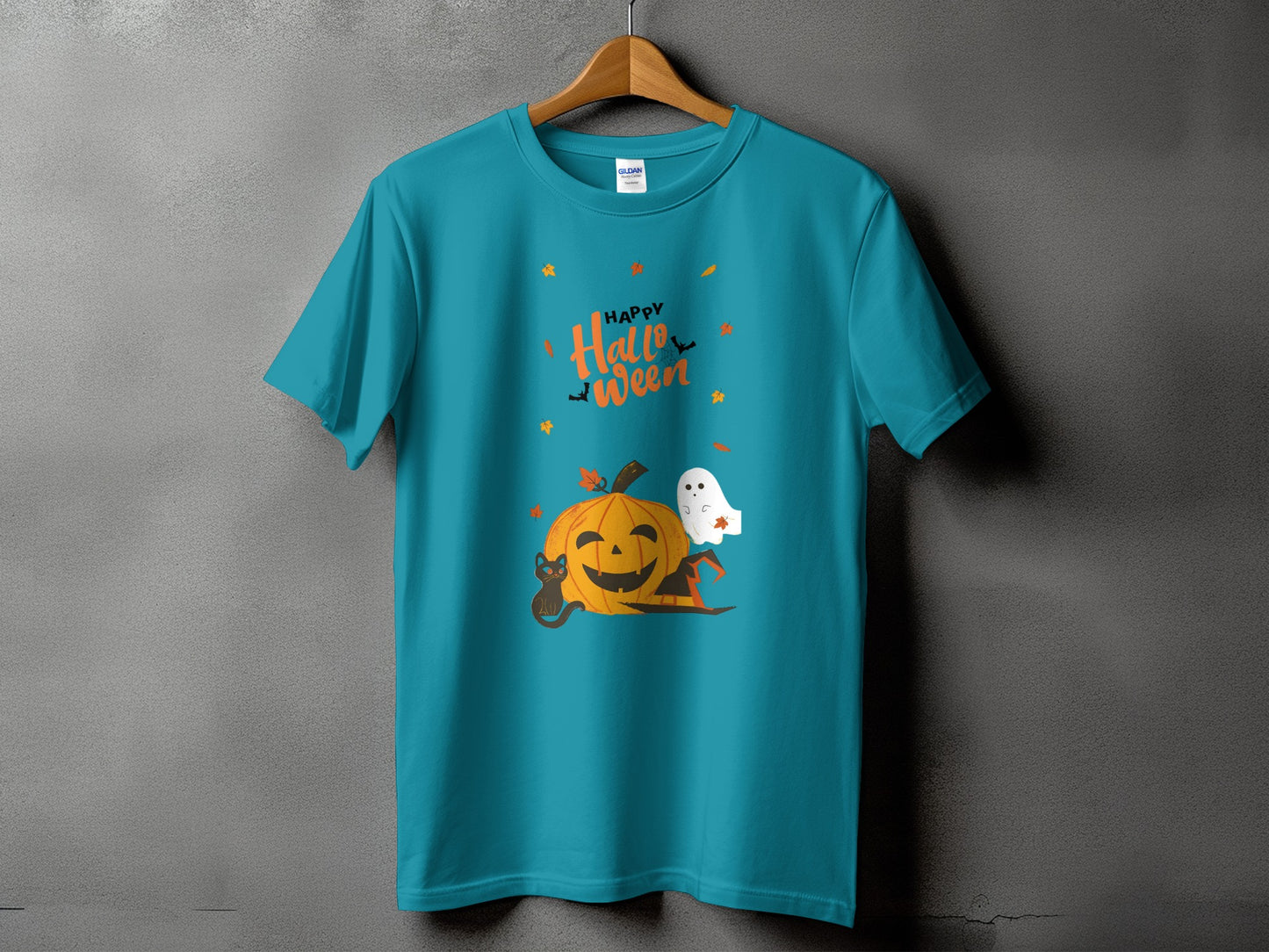 Turquoise t-shirt with Halloween graphic featuring a pumpkin, black cat, ghost, and text.