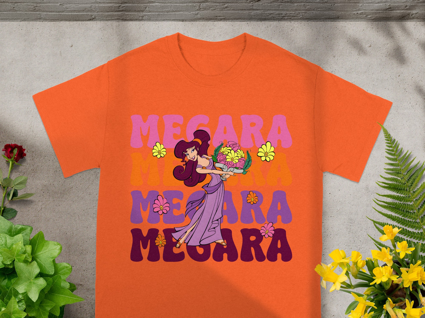 Orange t-shirt with "Megara" text and character illustration.