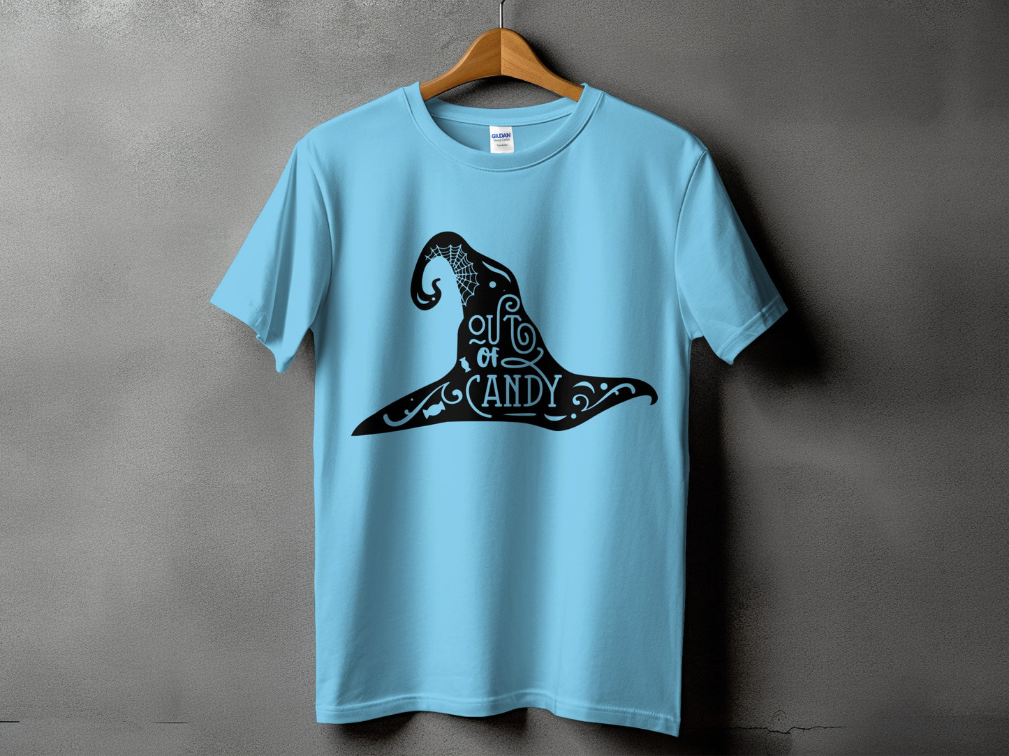 Light blue t-shirt with black witch hat graphic that says "out of candy".