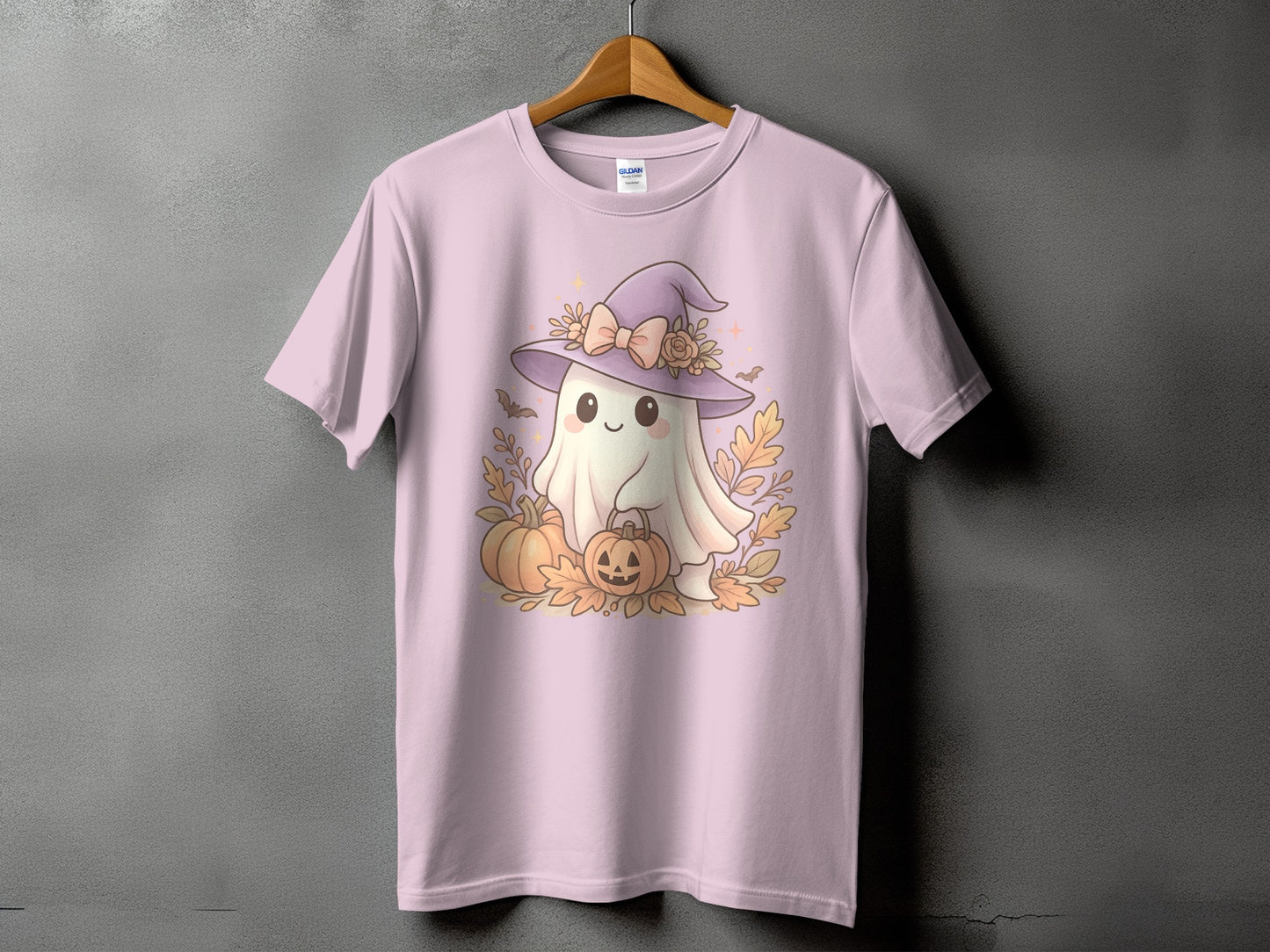 Pink t-shirt with a cute ghost wearing a witch hat and holding pumpkins.
