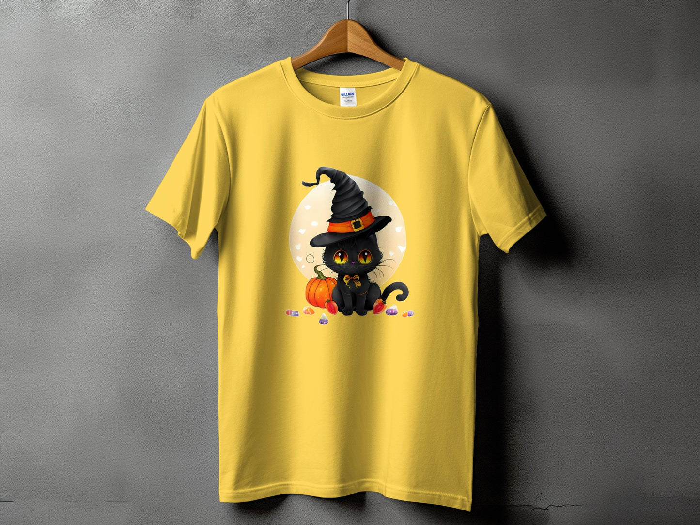 Yellow t-shirt with cartoon black cat wearing witch hat and candy corn.